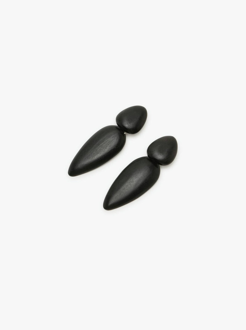 A pair of black acacia earrings with a silver plated brass clip, presented against a white background.