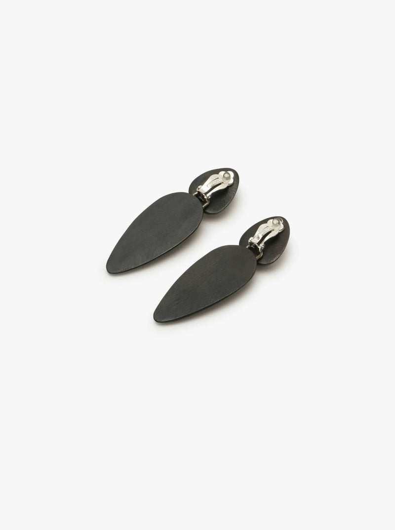 A pair of black acacia earrings with a silver plated brass clip, presented against a white background.