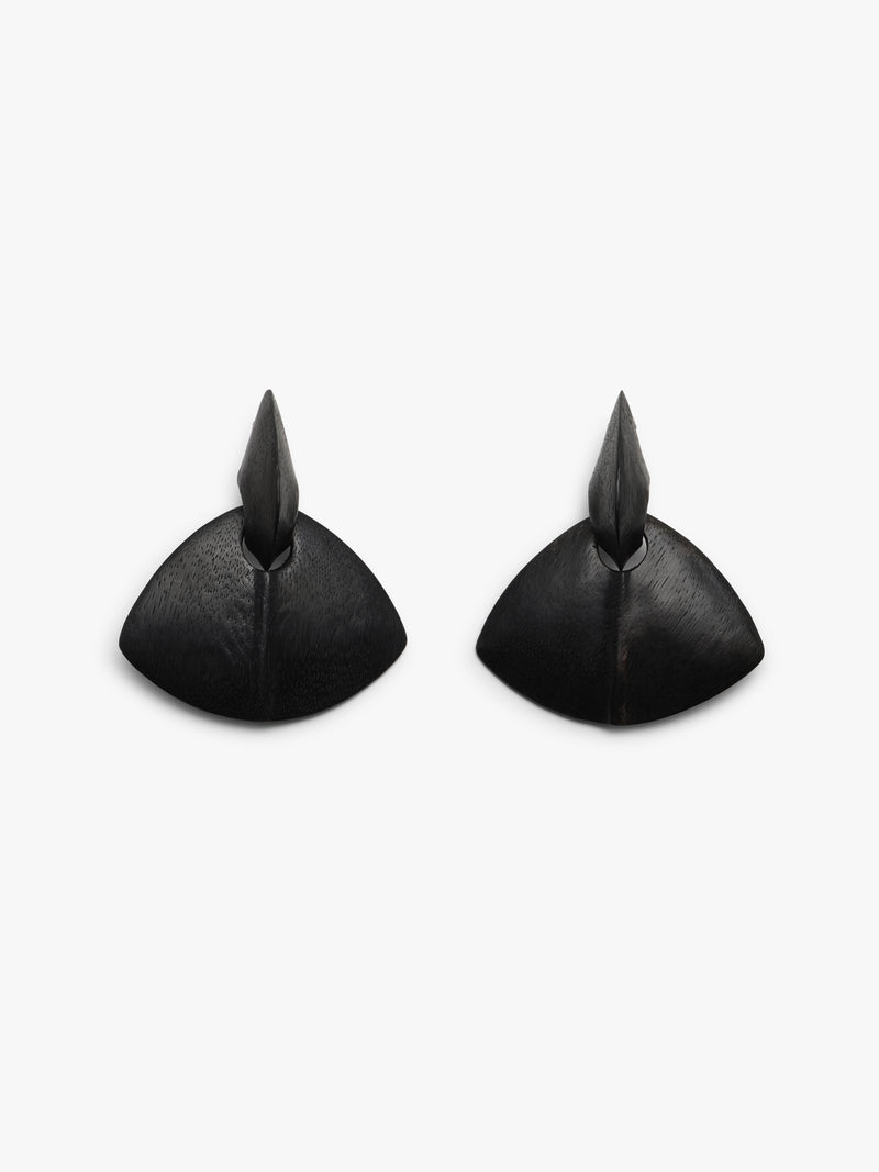 black sculptural earrings on a white background