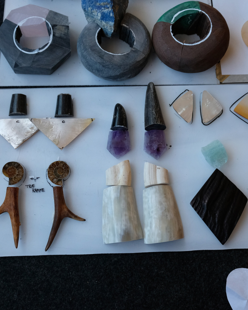 Collection of various stone carvings and natural specimens on a white surface