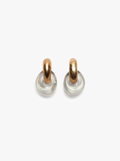 A pair of Havana earrings featuring clear and gold colors with earclips, made from acrylic and gold foil, displayed against a white background.