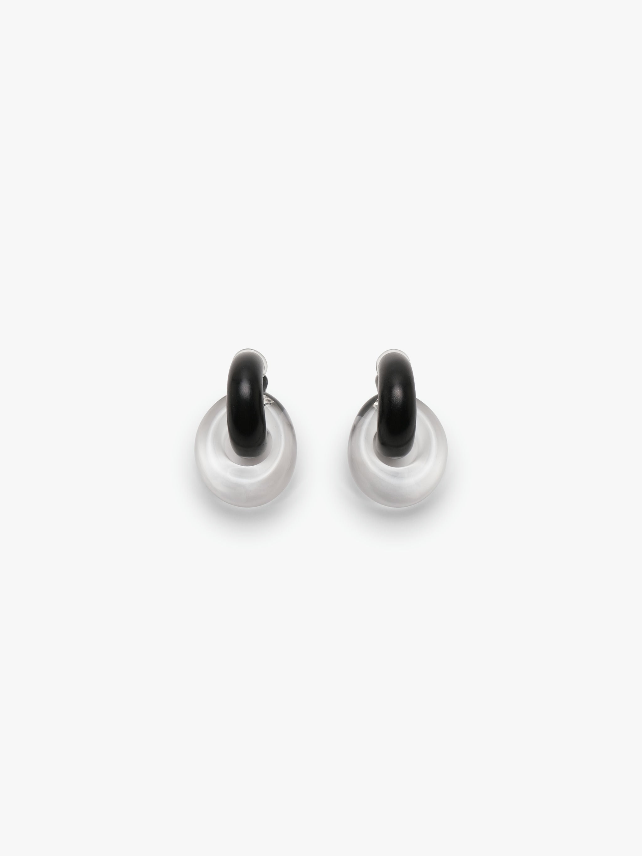 Pair of black and white earrings on a white background
