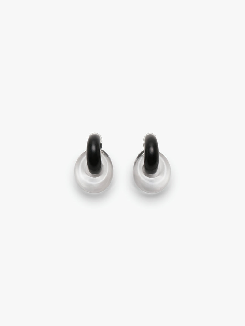Pair of black and white earrings on a white background