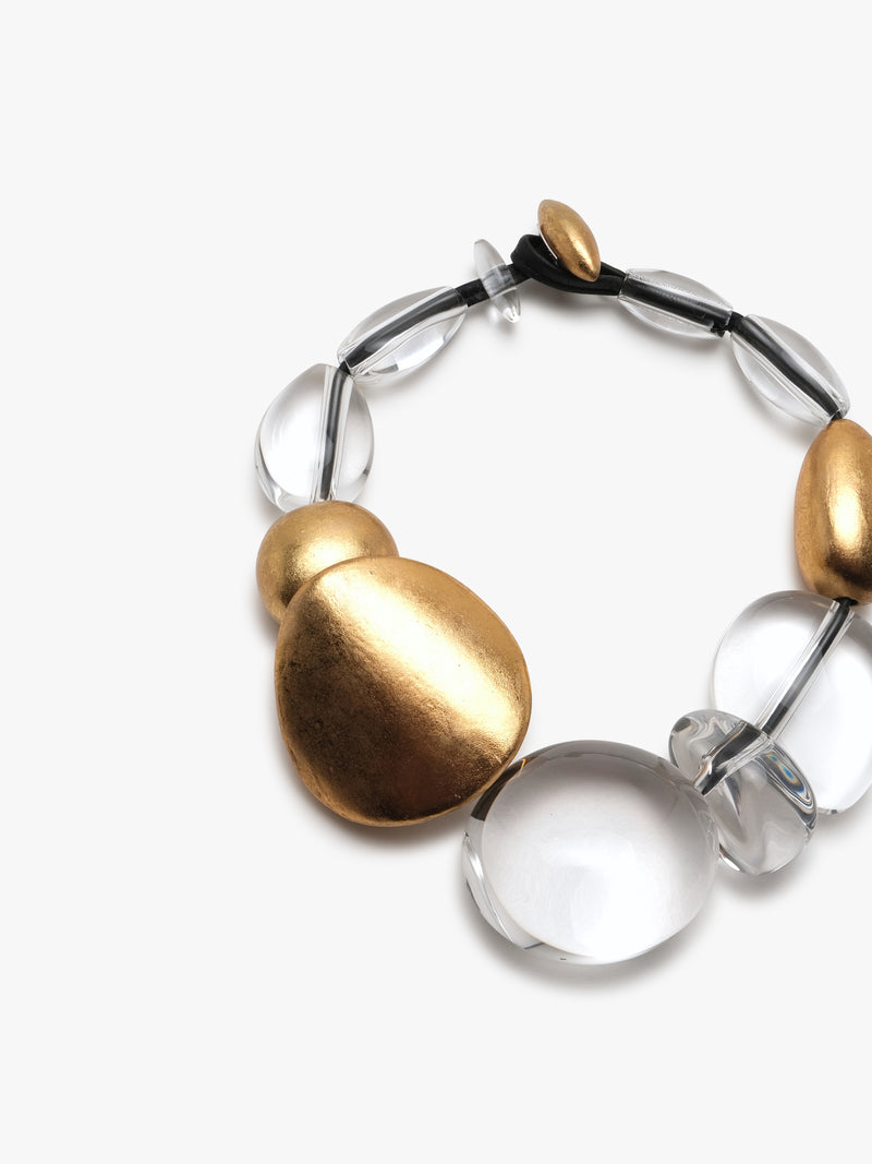 Necklace with a mix of clear and goldfoil beads on a white background