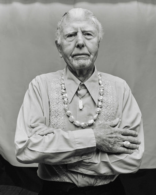 A person with a baroque pearl necklace, part of the Mint Collection, displaying a semi-precious stone.