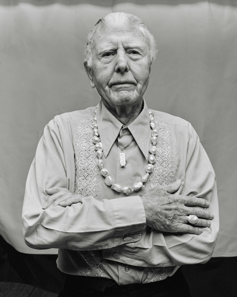A person with a baroque pearl necklace, part of the Mint Collection, displaying a semi-precious stone.