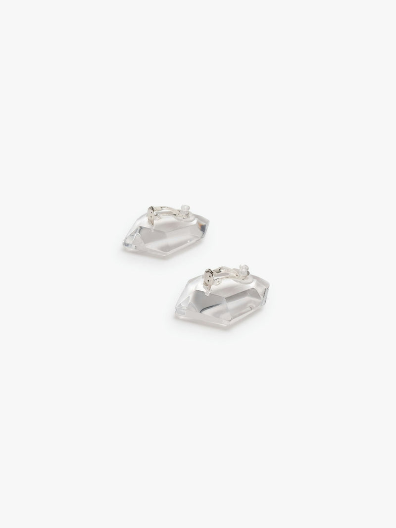 A pair of transparent acrylic earrings with a geometric shape, attached to silver plated brass ear clips.