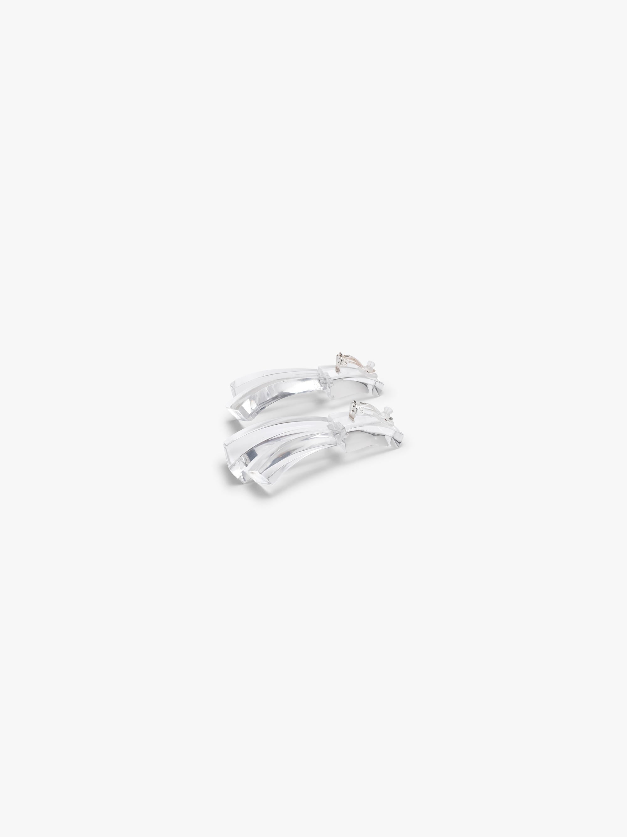 Pair of transparent earrings on a white background