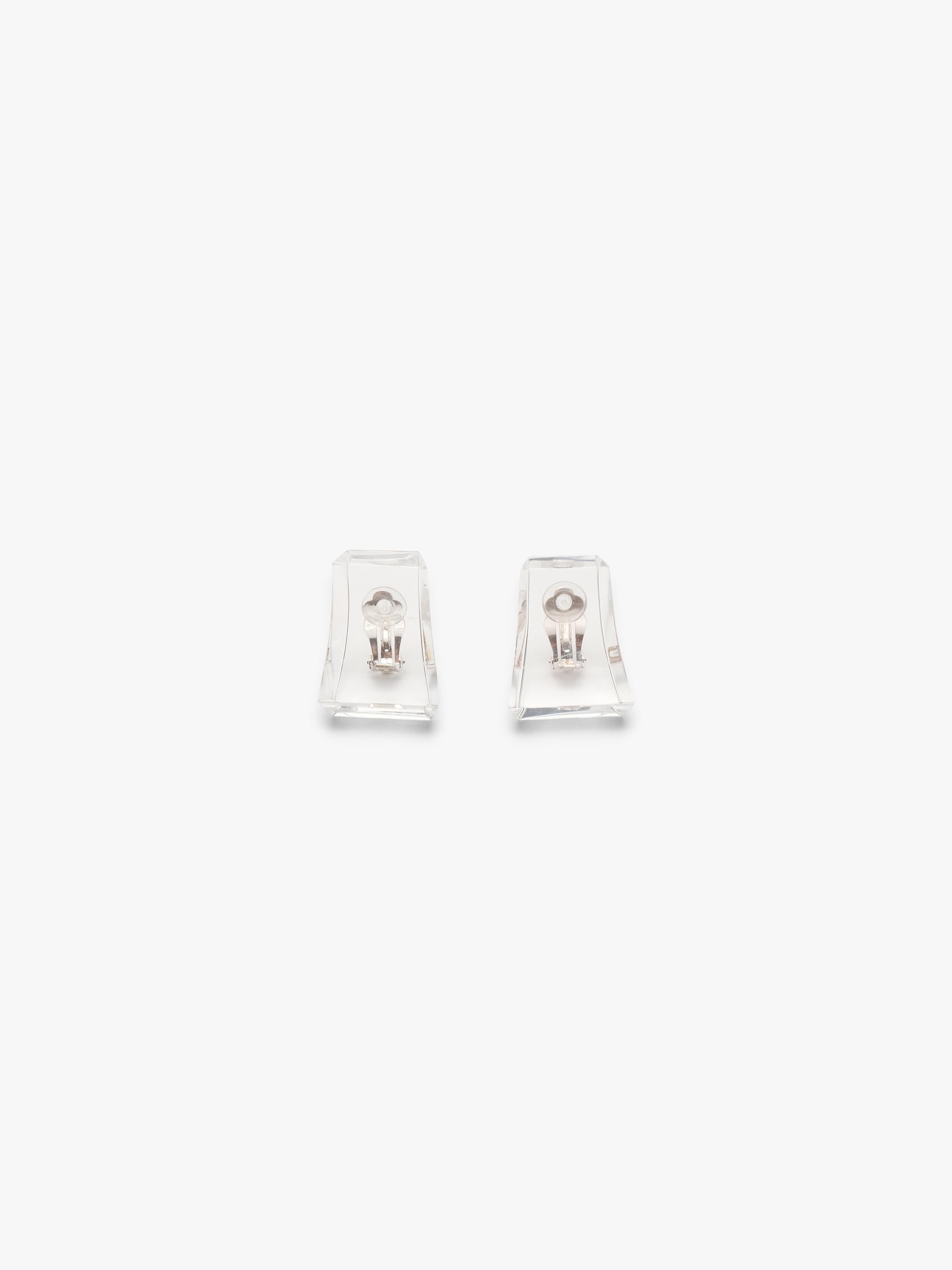 A pair of clear acrylic earrings on a white background