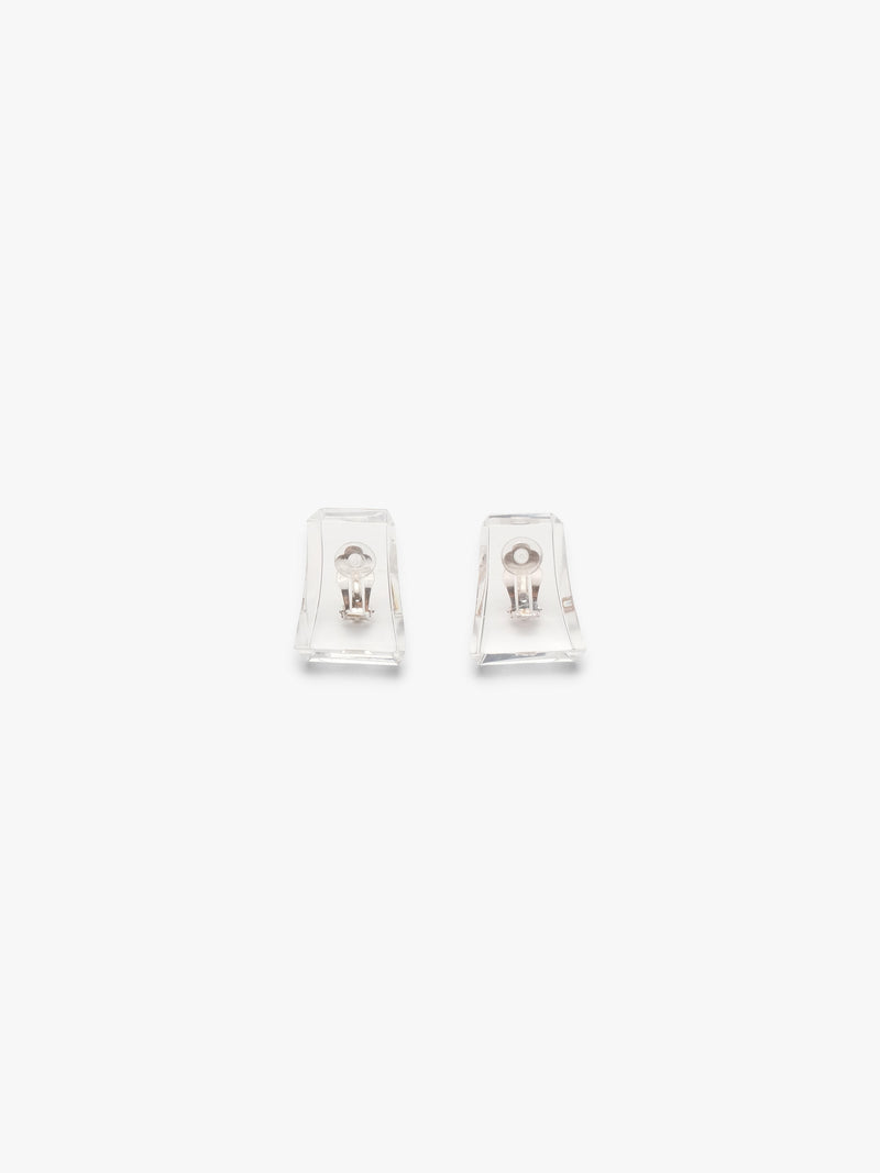 A pair of clear acrylic earrings on a white background