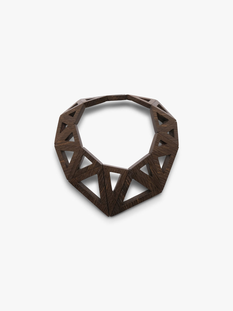A dark brown geometric wooden necklace with an open, triangular lattice design, photographed on a clean white background.
