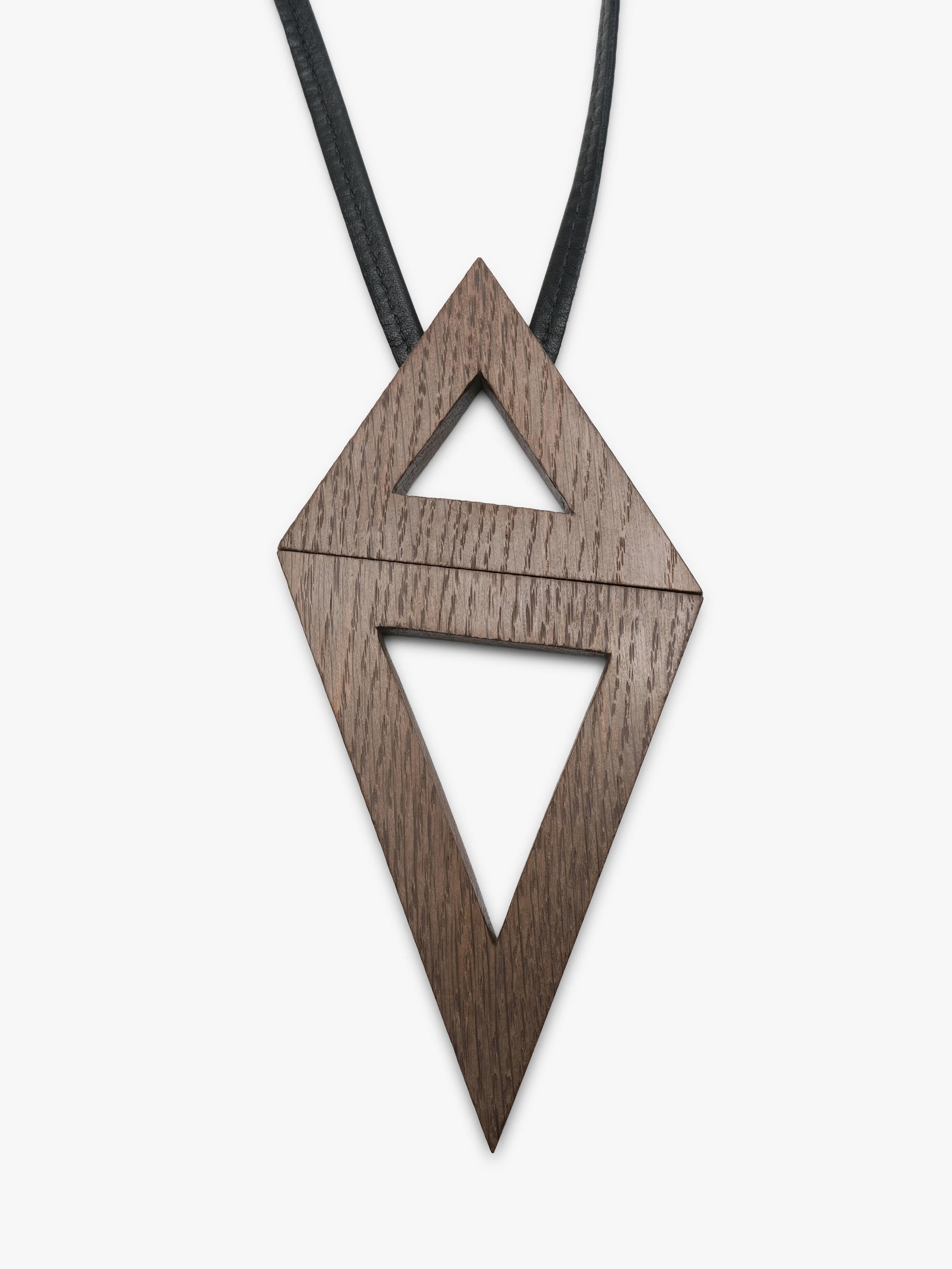 A geometric wooden pendant necklace with a dark brown wood grain finish, suspended on a thin black cord with a small black bead, shown against a plain light gray background.