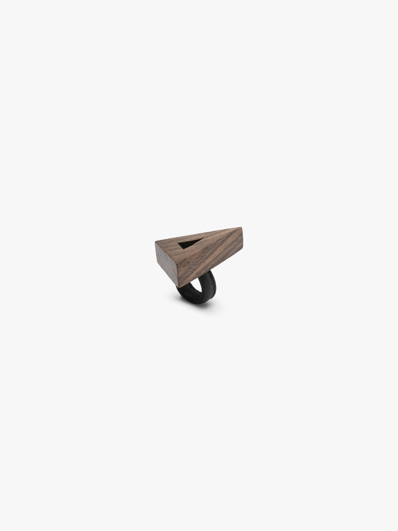 A triangular wooden ringwith a natural wood grain finish with a black leather band, shown on a plain light gray background.