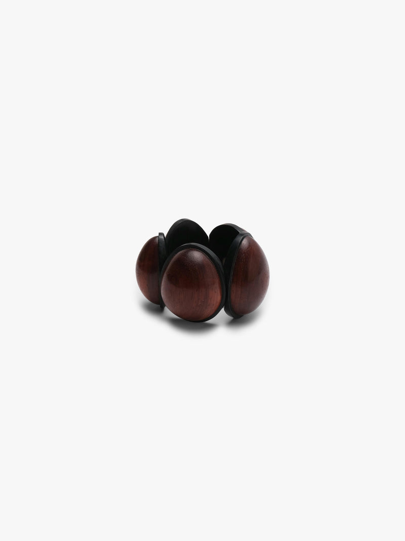 A bracelet featuring smooth, teardrop-shaped reddish-brown wooden beads set in a matte black wooden band, centered on a light gray background.