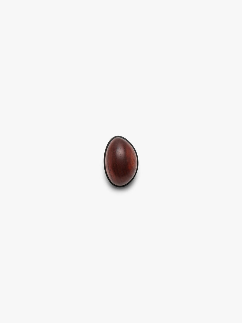 A warm redtoned wooden ring shown on a clean off-white background with a soft shadow.