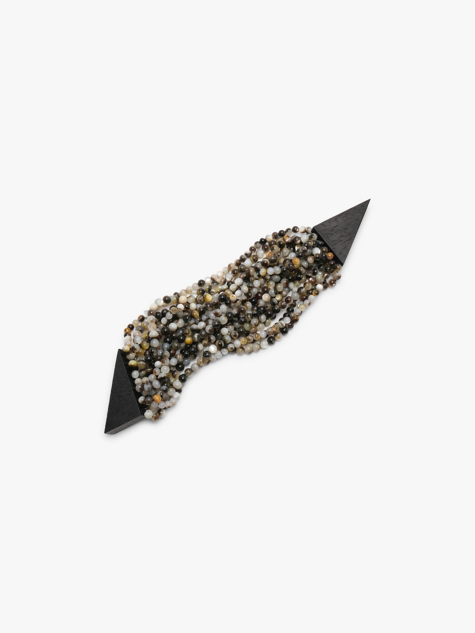 A wide pearl beaded wrap bracelet with a faceted black acacia  lock, displayed on a clean white background.