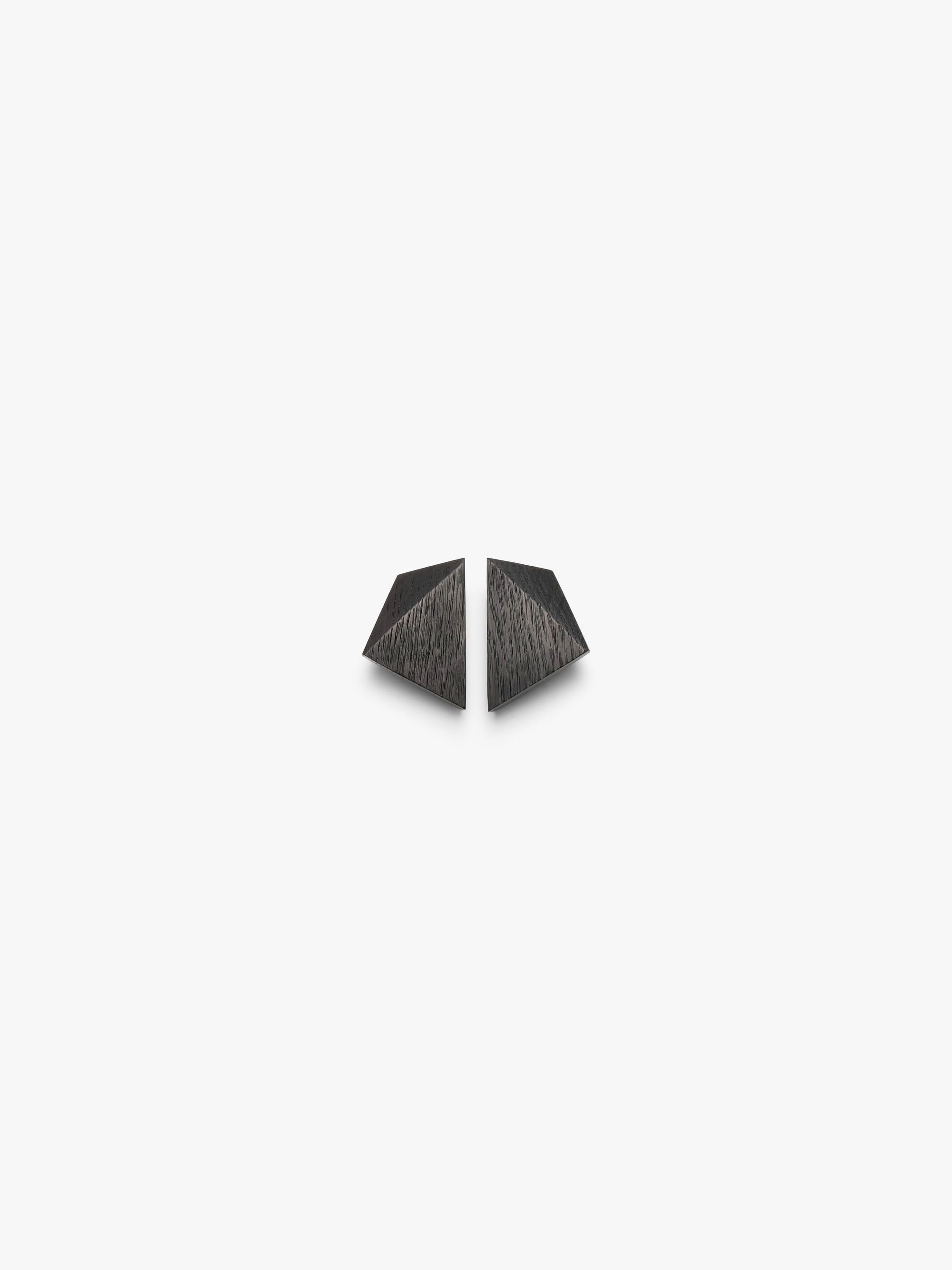 A pair of small, dark gray geometric stud earrings with a textured, brushed finish, shown on a plain white background.