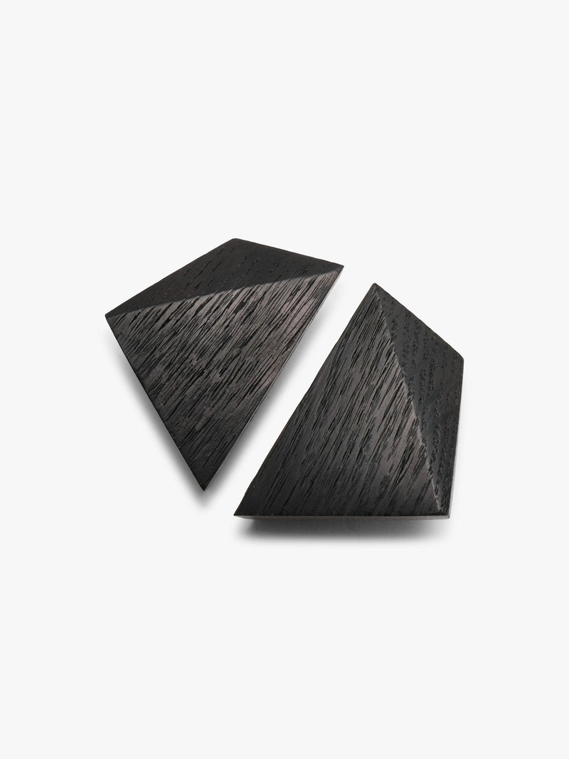 A pair of small, dark gray geometric stud earrings with a textured, brushed finish, shown on a plain white background.