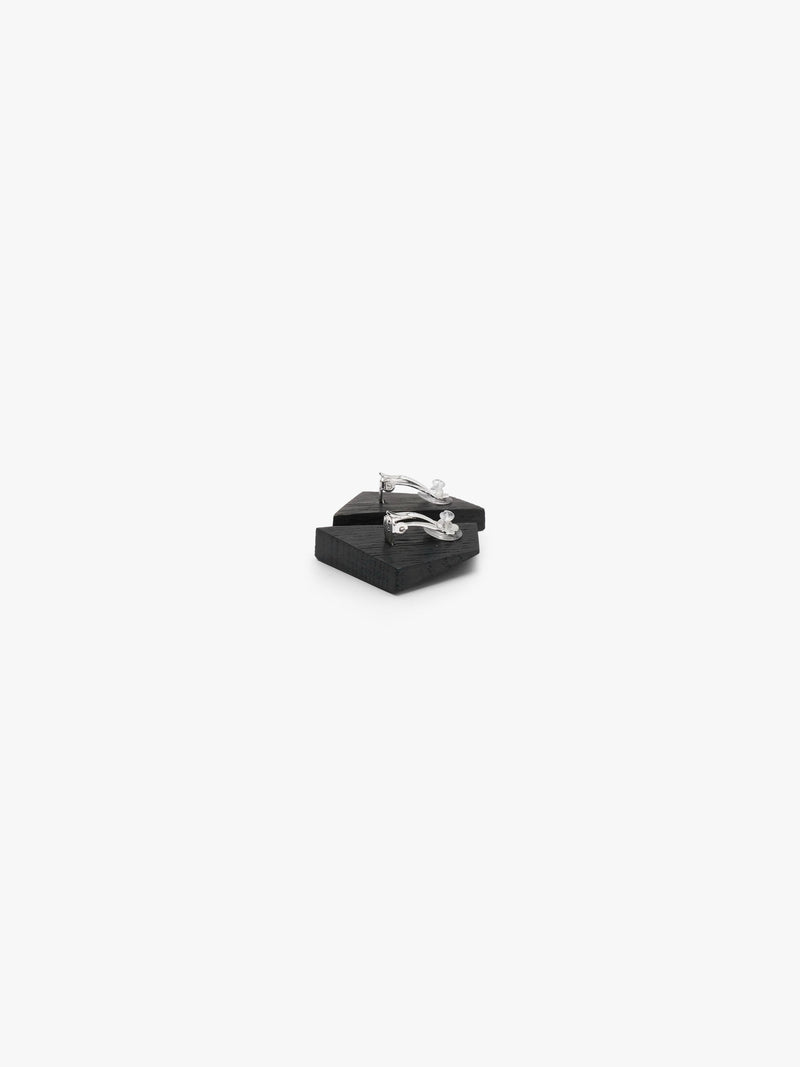 A pair of small, dark gray geometric stud earrings with a textured, brushed finish, shown on a plain white background.