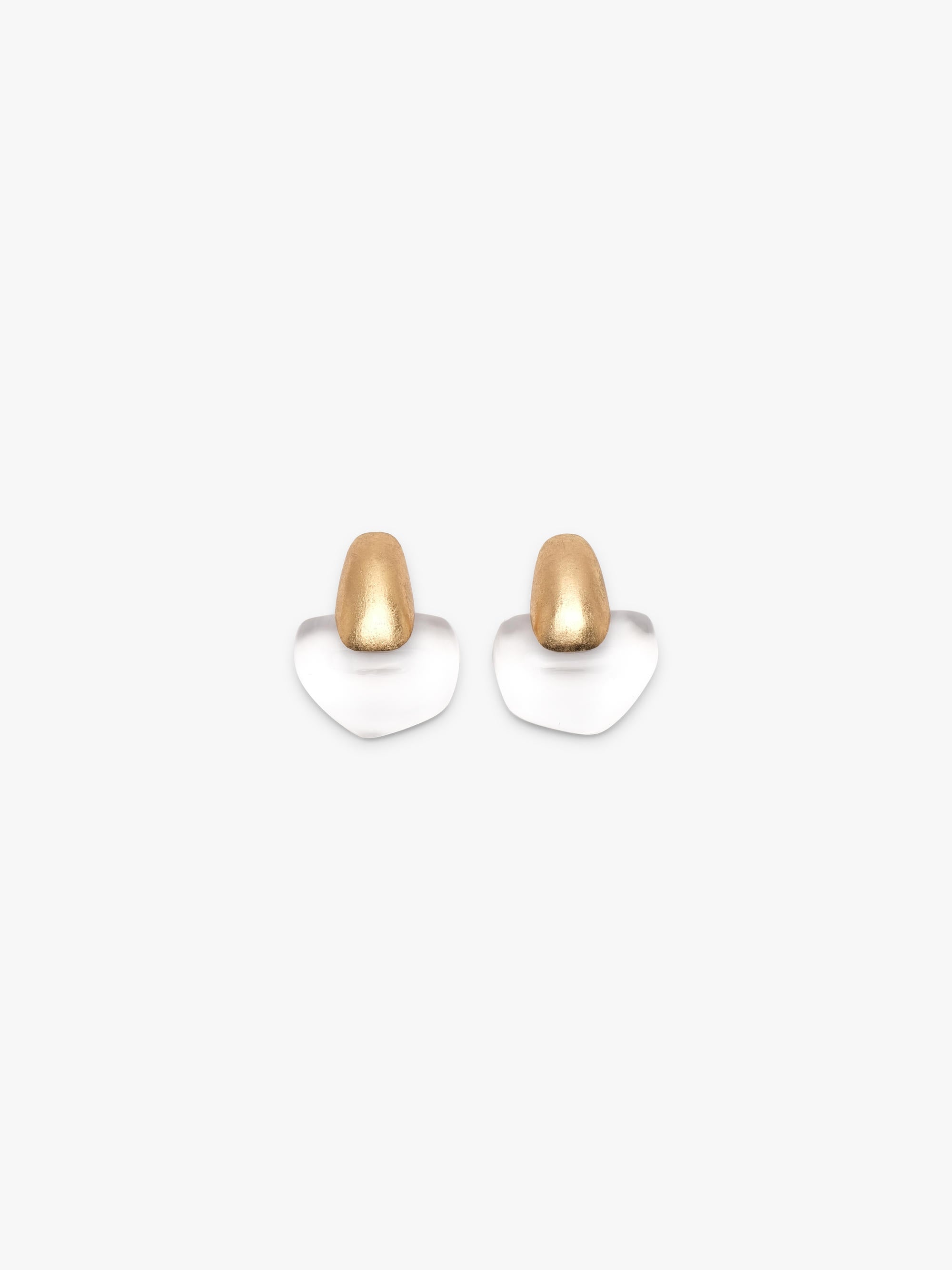 A pair of earrings featuring a small, rounded gold-toned top and a flat, petal-shaped white base, shown against a solid off-white background.