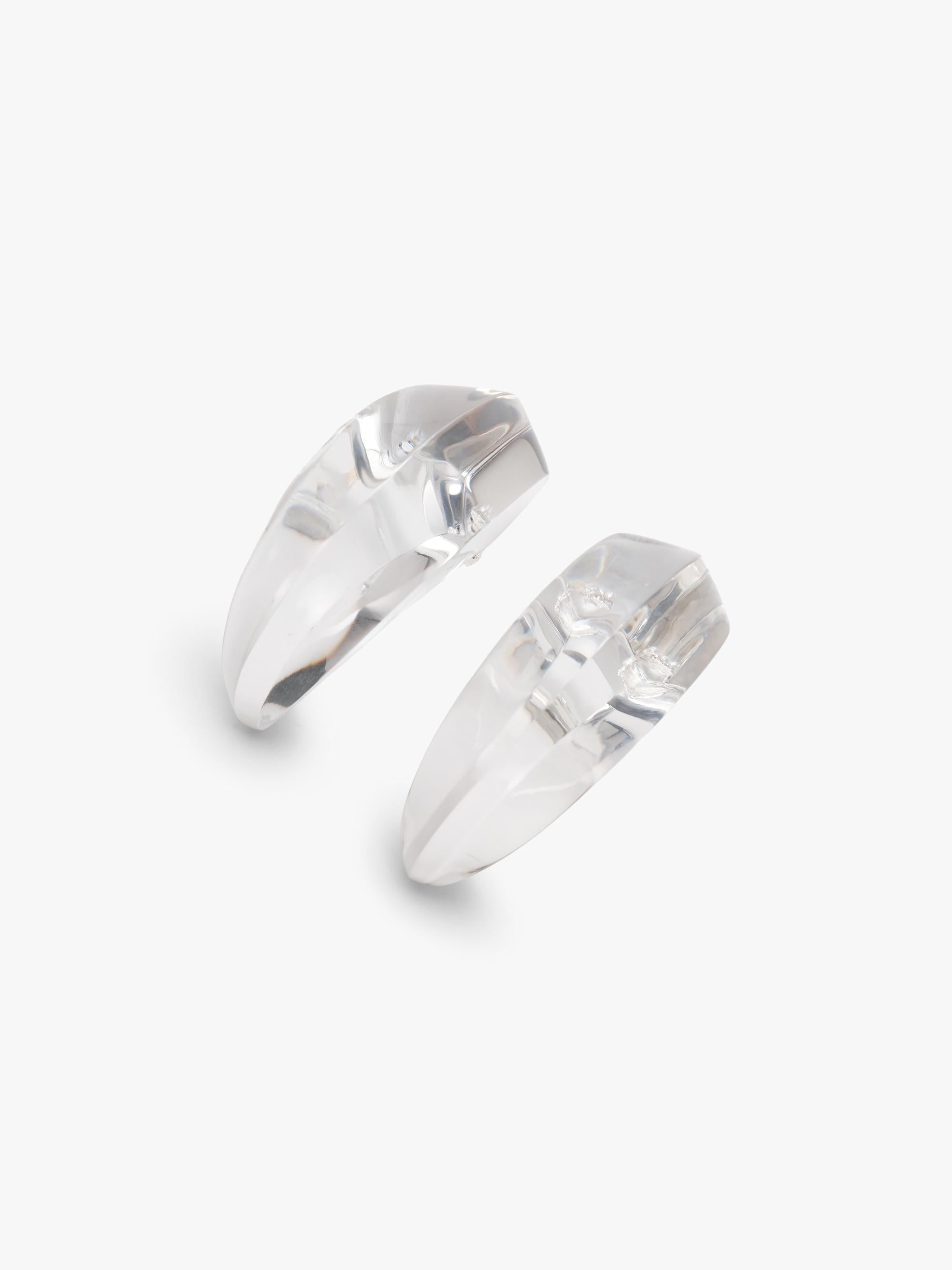 transparent curved earrings displayed on a white background