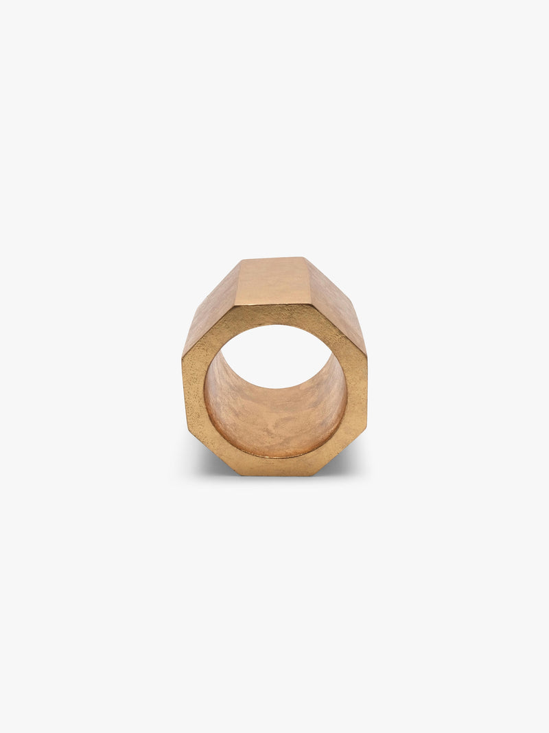 A gold geometrical bracelet displayed on a white background