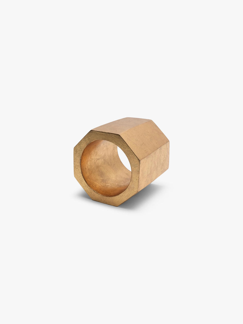 A gold geometrical bracelet displayed on a white background