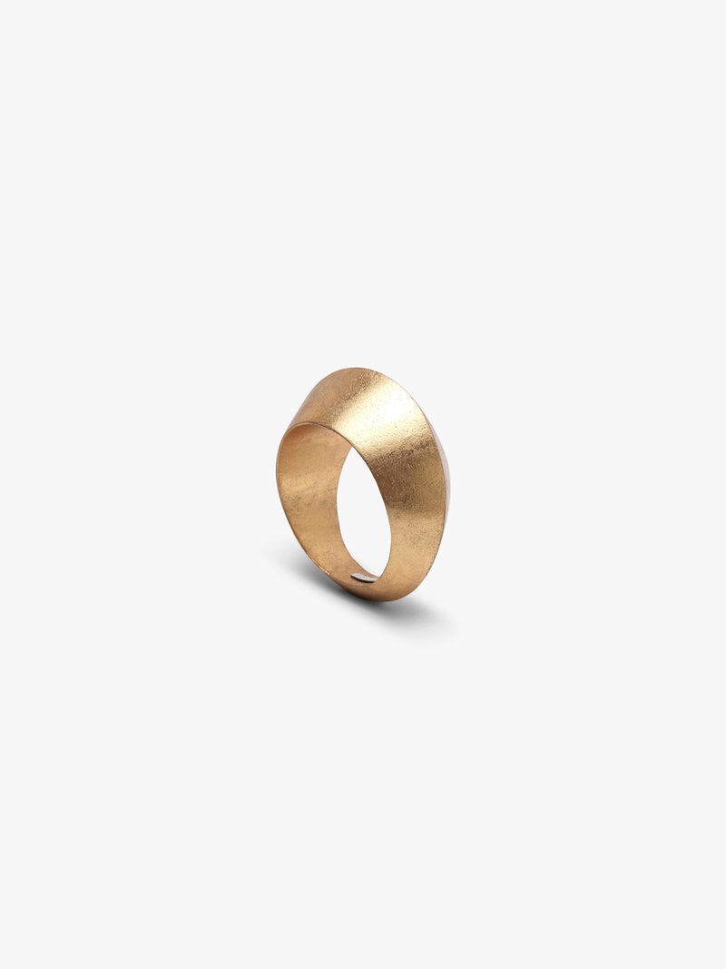 A curved gold bracelet, displayed on a white background