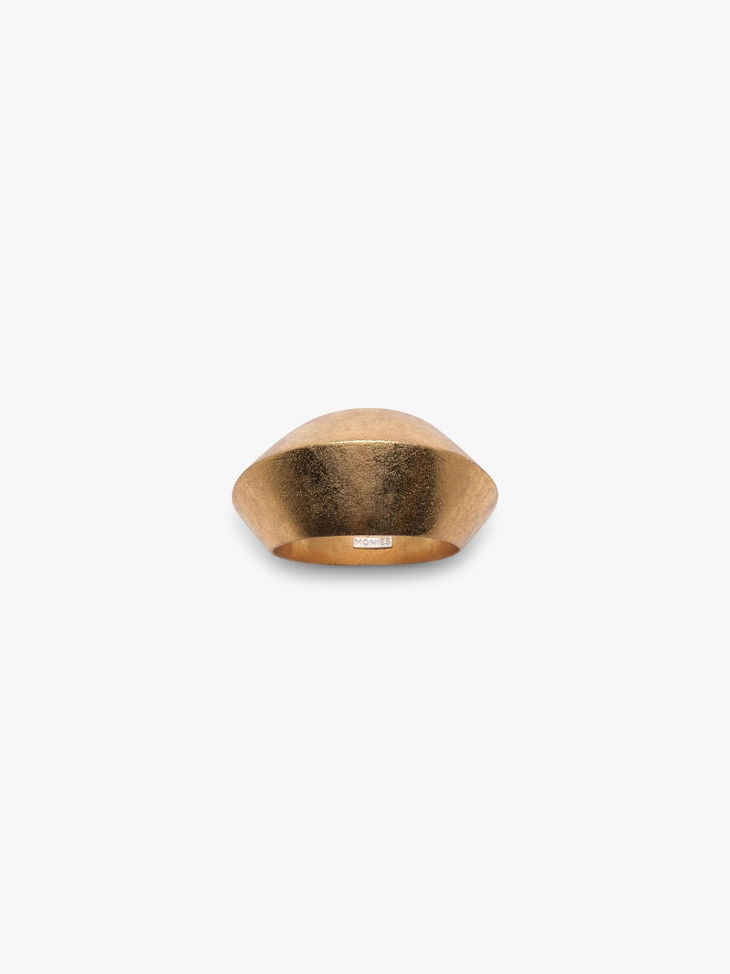 A curved gold bracelet, displayed on a white background