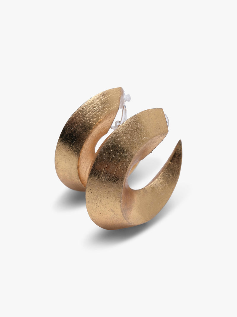 A pair of gold crescent-shaped hoop earrings with a textured finish, displayed on a clean, light off-white background.