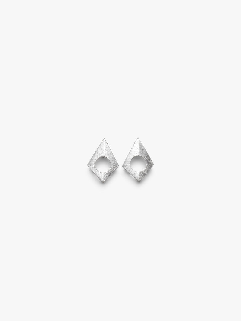 A pair of geometrical earrings with a centered hole covered in silverfoil, displayed on a white background