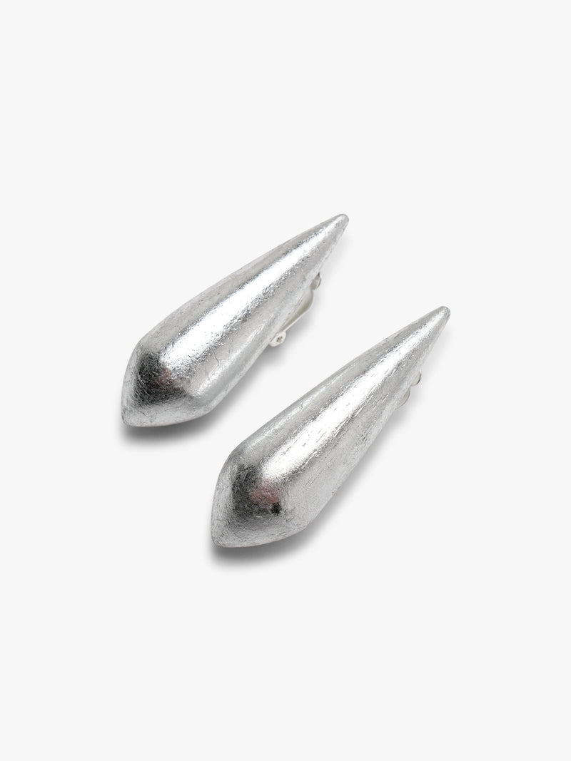 Handcrafted from acacia with a silverfoil finish, these earrings have an elongated sculptural shape with softly faceted surfaces.