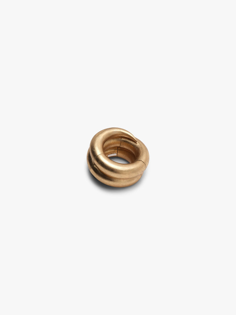 A spiraled gold bracelet, displayed on a white background