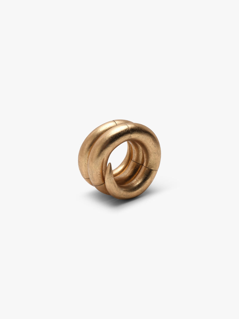 A spiraled gold bracelet, displayed on a white background
