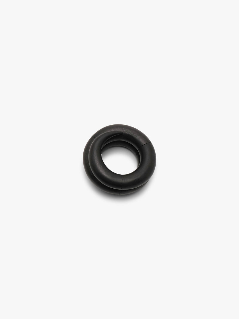 Black spiralshaped bracelet, displayed on a white background