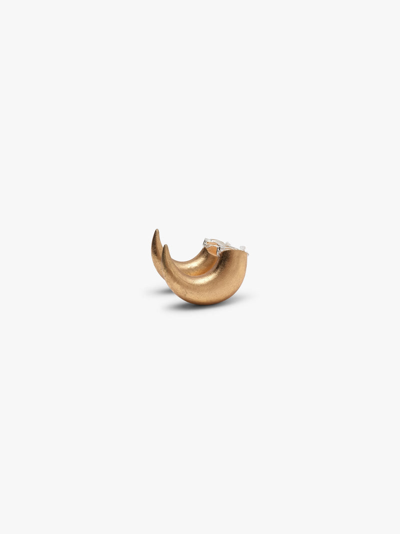 A pair of gold crescent-shaped hoop earrings with a small silver clip on feature, shown on a plain light gray background.
