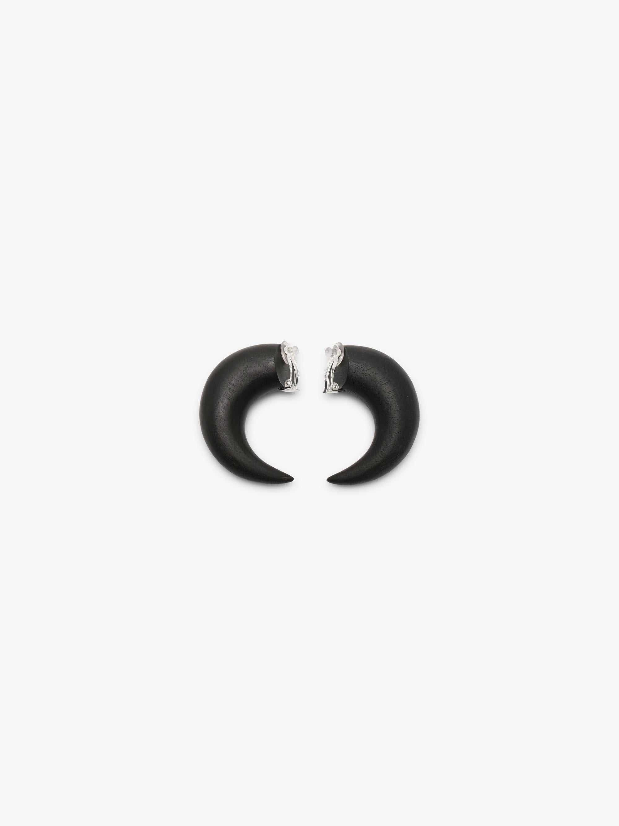 A pair of matte black earrings shown against a solid white background.
