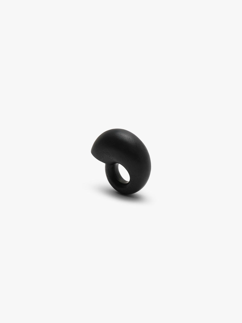 A chunky snailshaped ring in black displayed on a white background
