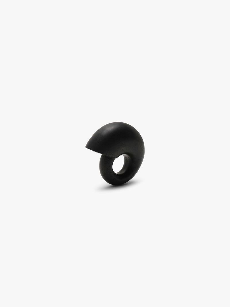 A chunky snailshaped ring in black displayed on a white background