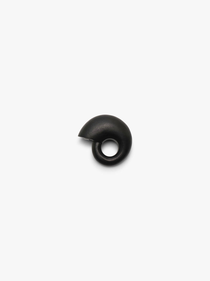 A chunky snailshaped ring in black displayed on a white background