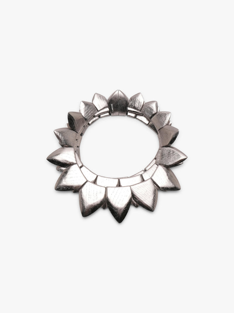 Silver necklace with many triangular shapes form into a circle, displayed on a white background