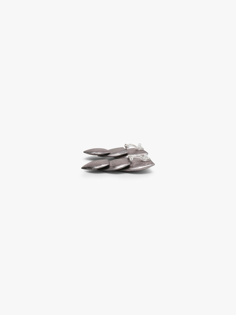 Silver earrings with a flower padel kike structure, displayed on a white background