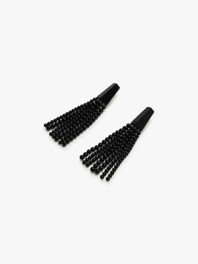 A pair of long black earrings with obsidian stone and acrylic tassels