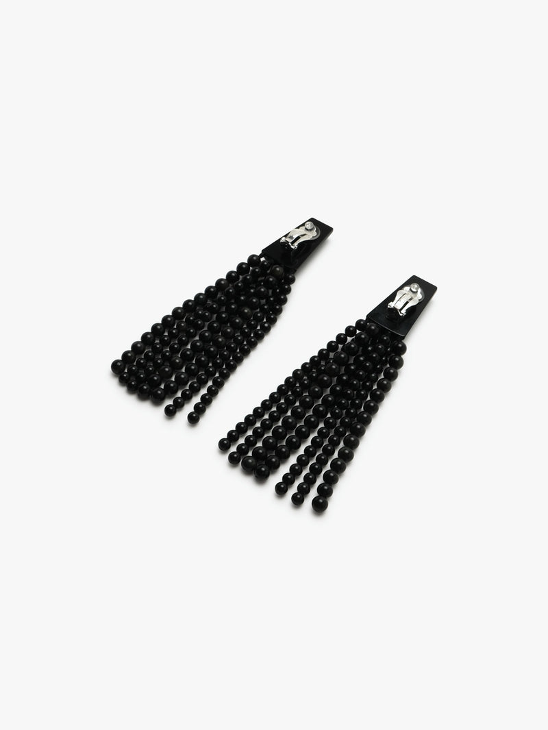 A pair of long black earrings with obsidian stone and acrylic tassels