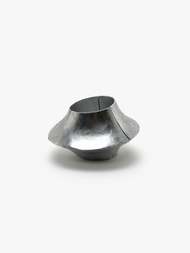 A silver foil bracelet with an elastic band, displayed on a plain background.