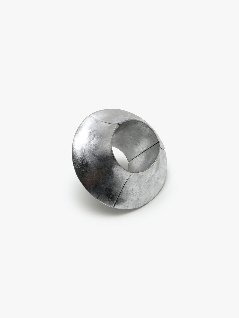 A silver foil bracelet with an elastic band, displayed on a plain background.