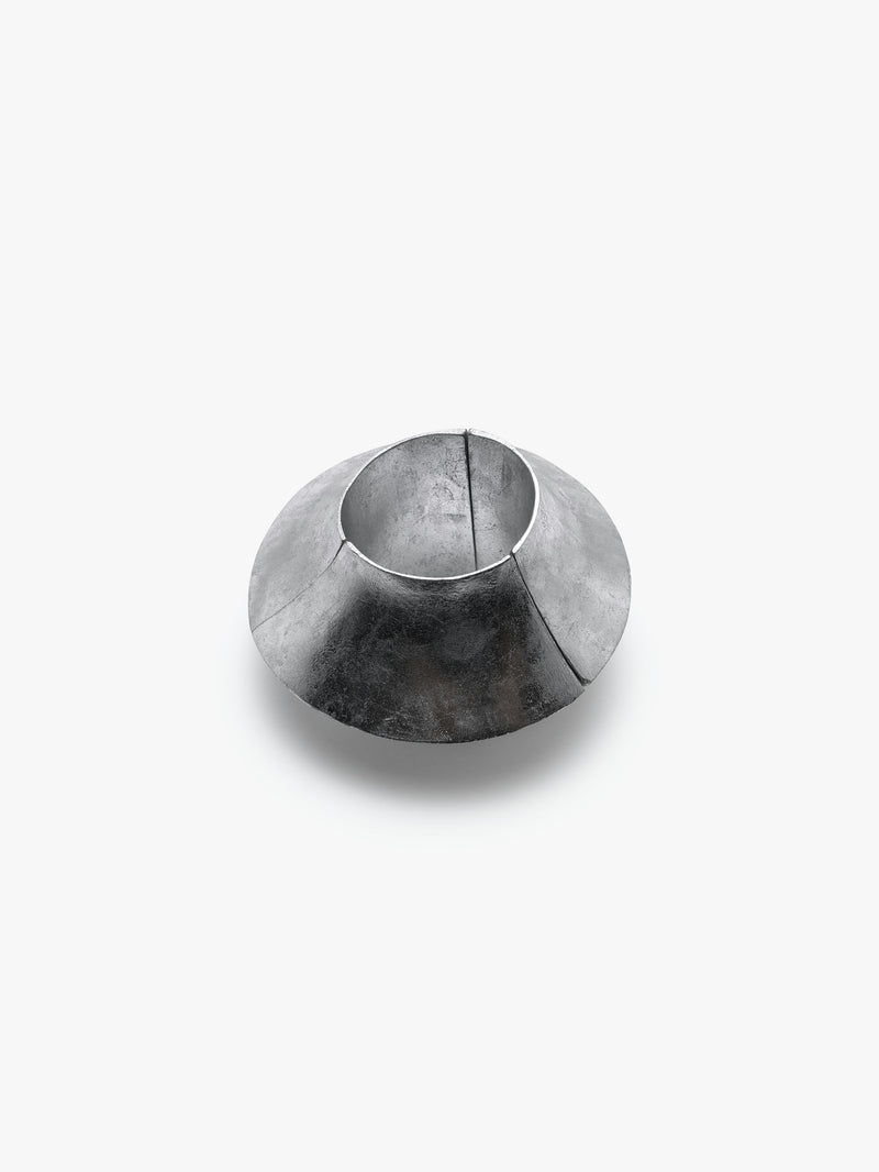 A silver foil bracelet with an elastic band, displayed on a plain background.