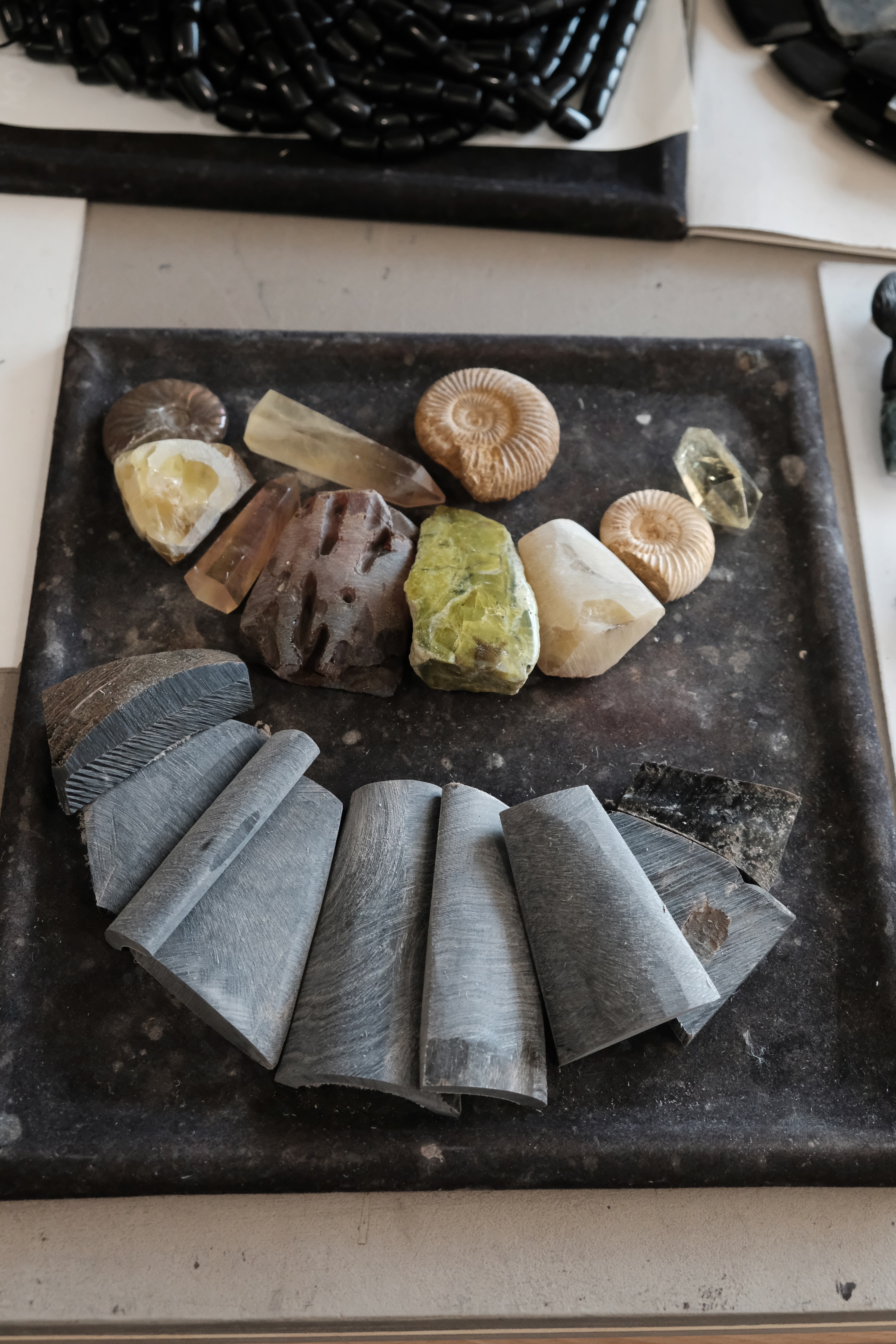 Stones and bone layed out on a black workbench