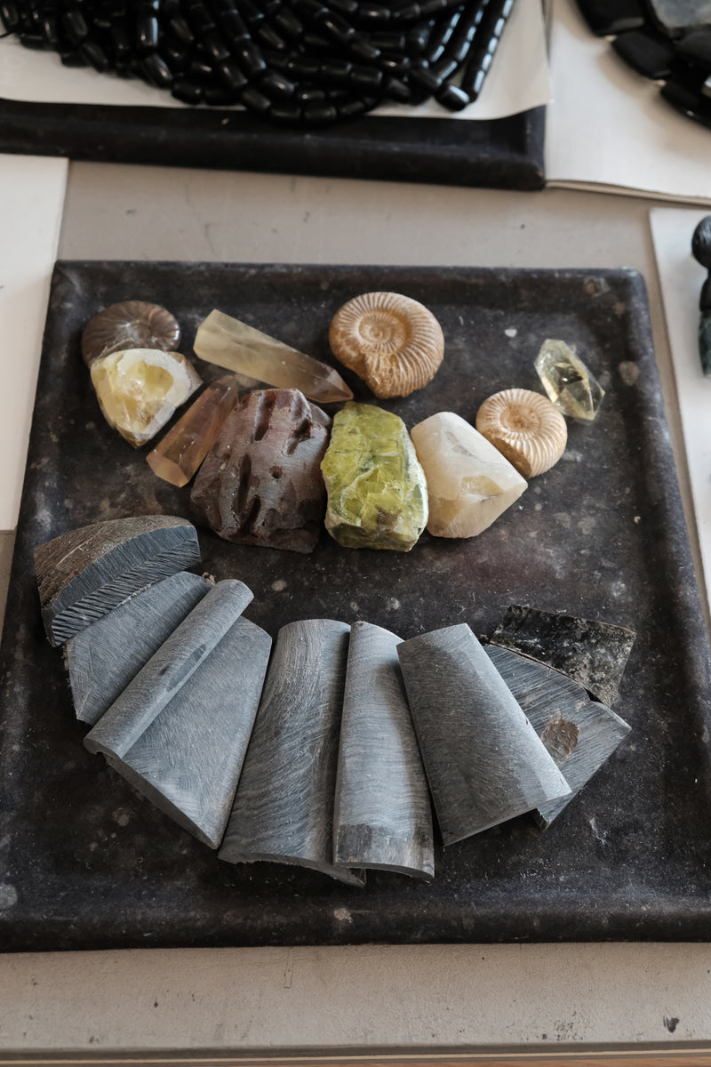 Stones and bone layed out on a black workbench