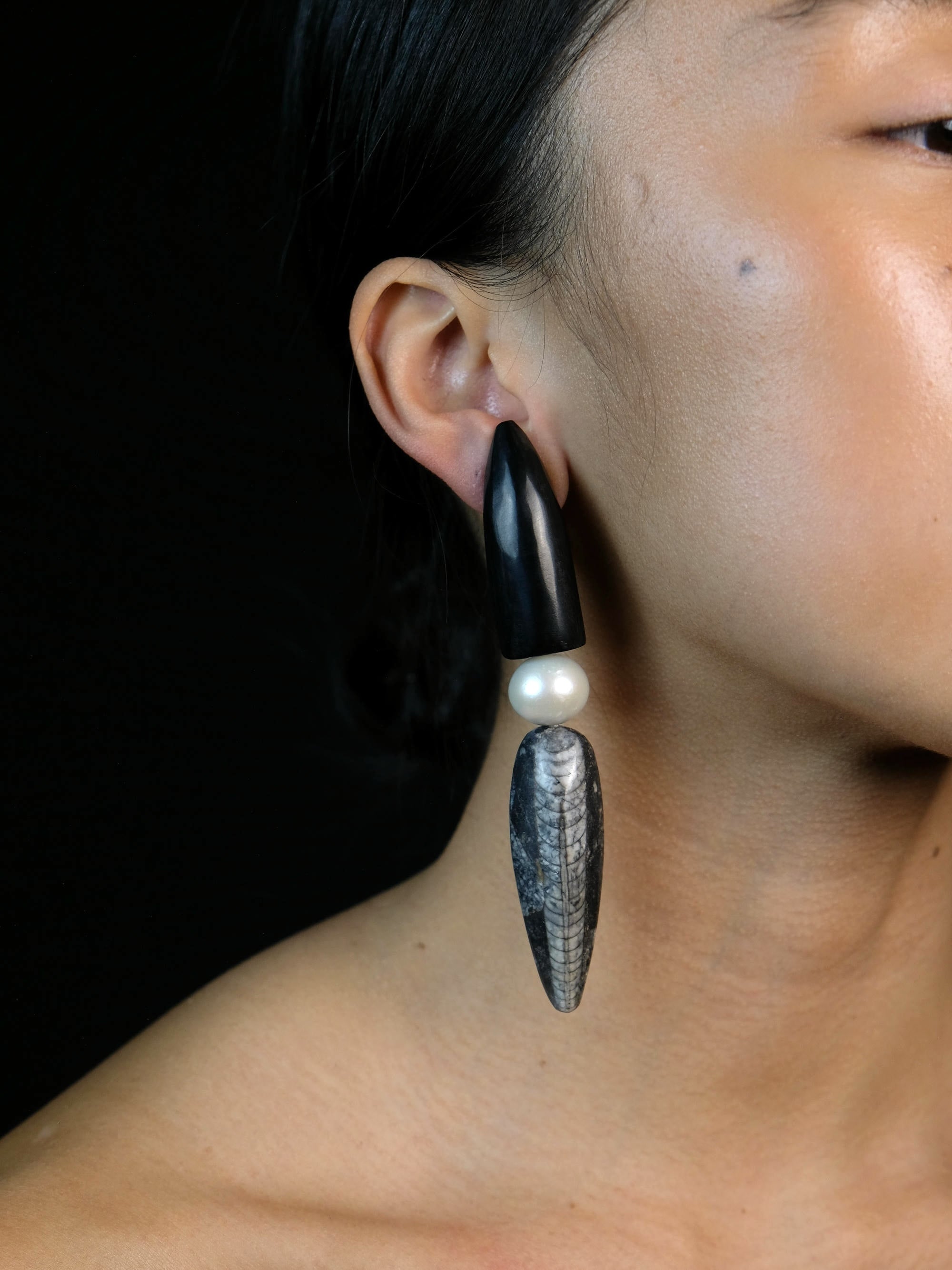 Earrings: horn, freshwater pearls, orthorecas